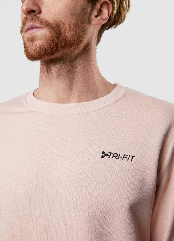 Man wearing TRI-FIT dusty pink crew neck sweater