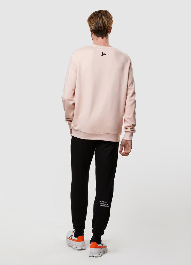 Man wearing TRI-FIT dusty pink crew neck sweater