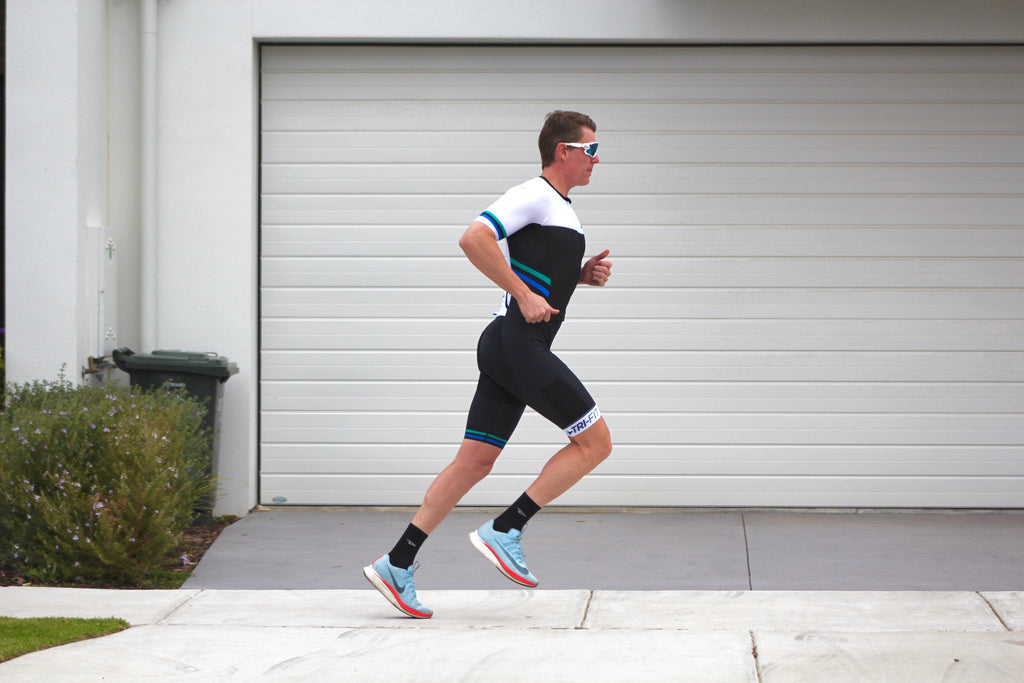 Man running along the street in the EVO mens tri suit