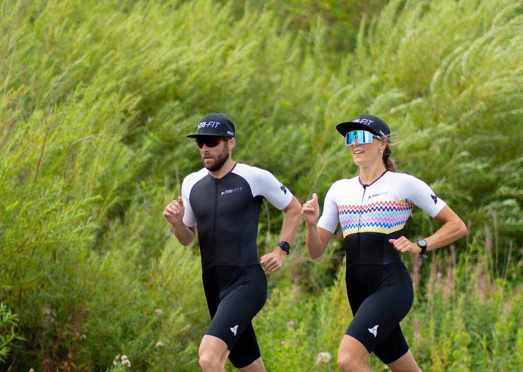 Man and Woman cycling in the sleeveless EVO tri suit