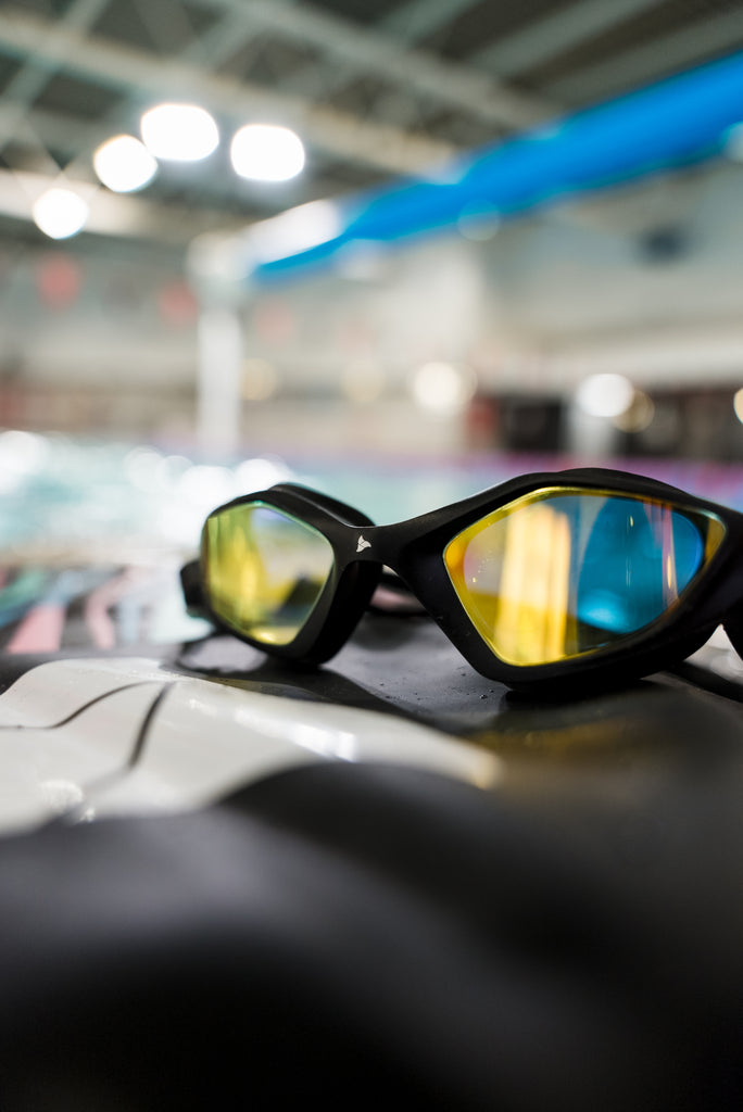 Female swimmer wearing TRI-FIT RAPID-X swim goggles in black