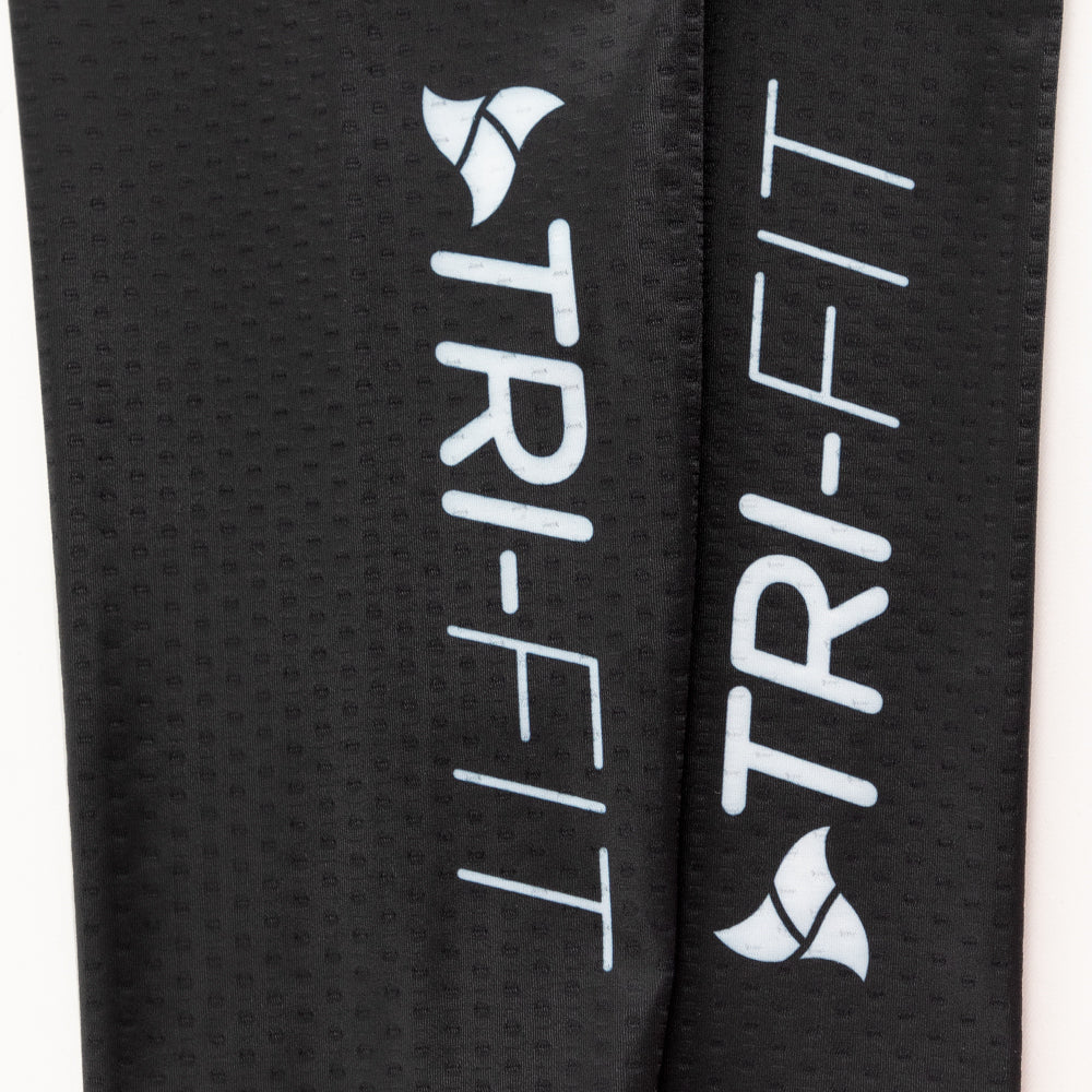 Detailed view of the TRI-FIT logo on black CORE Calf Sleeves with premium textured surface.