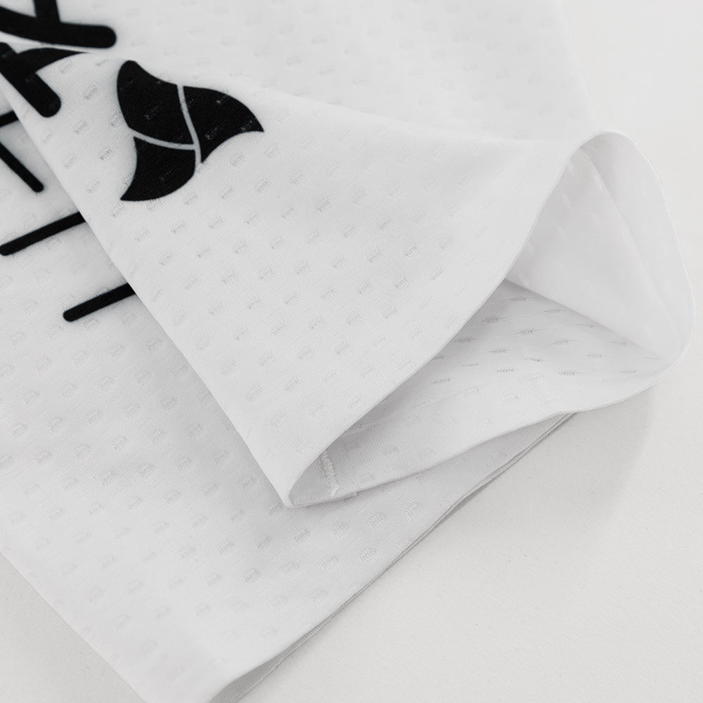 Detail shot of white CORE Calf Sleeves showing lightweight dimpled fabric and inner seam construction.