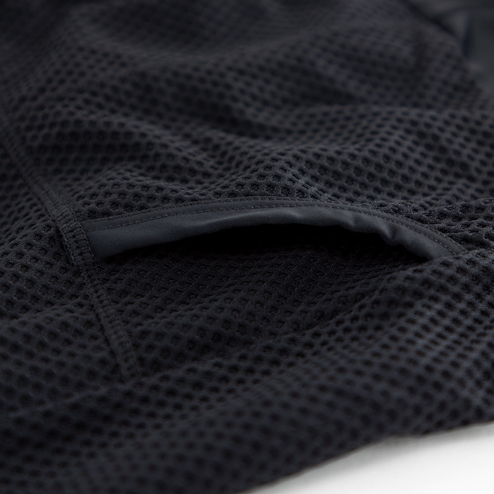 Close-up of rear pocket opening and internal stitching on VANGUARD tri-suit in plum